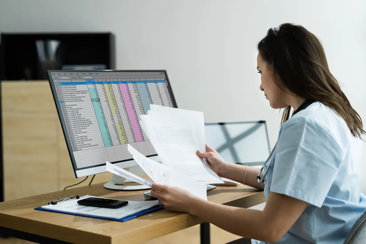Illustrative photograph of a healthcare professional reviewing records