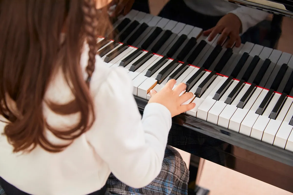 Illustrative photograph of hands playing a piano